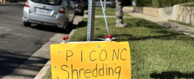 Yellow Pico shredding event sign standing in the grass